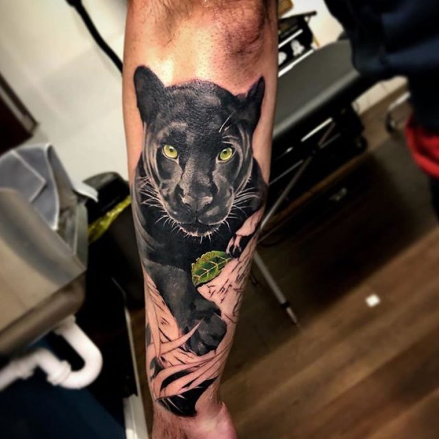Black and grey panther tattoo on the right inner